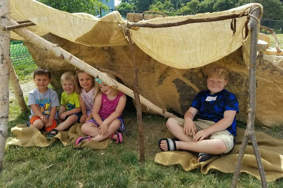 Fort building in the Dotson Back 40 nature play area at the Childrens Museum of Southern Minnesota Mankato