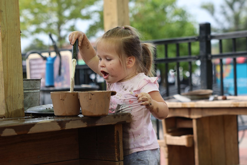 Mud Kitchen play in the H2GO Outdoor Water Gallery at the Childrens Museum of Southern Minnesota Mankato