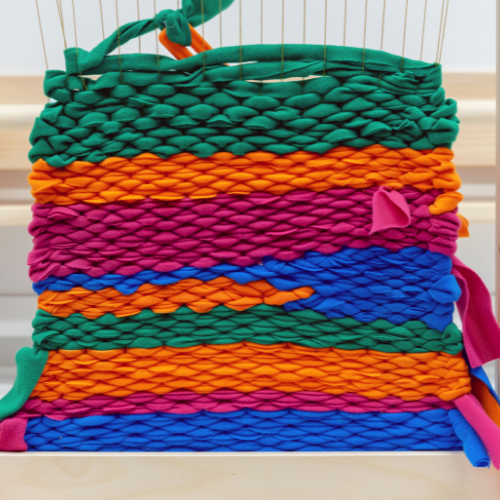 Weaving loom creative activity for kids at Childrens Museum of Southern Minnesota Mankato