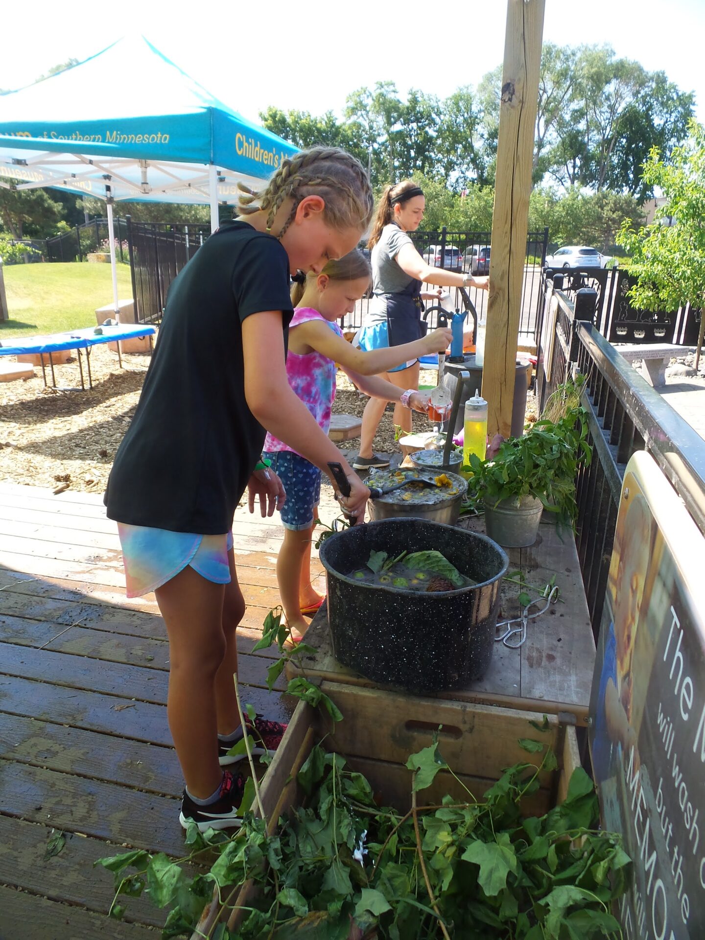 Sensory stimulation nature play in the Mud Kitchen at the Children's Museum Mankato