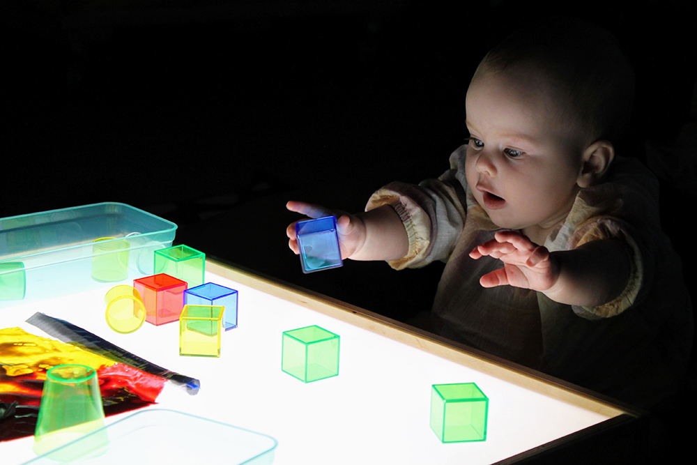 Baby exploring light colors and shapes at CMSM