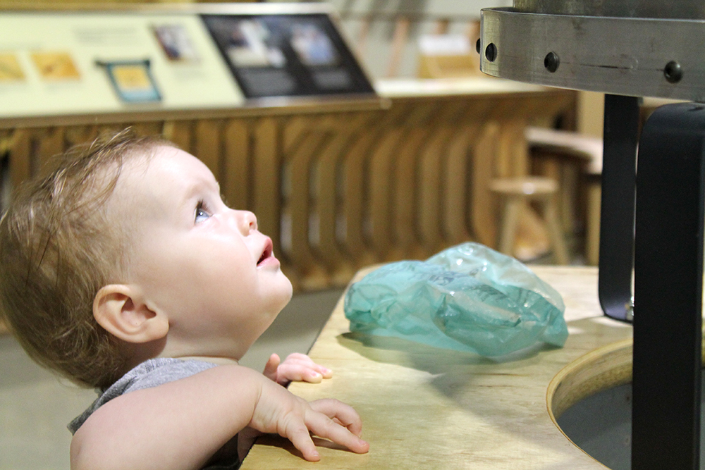 Baby exploring the Wind Tunnel CMSM mankato