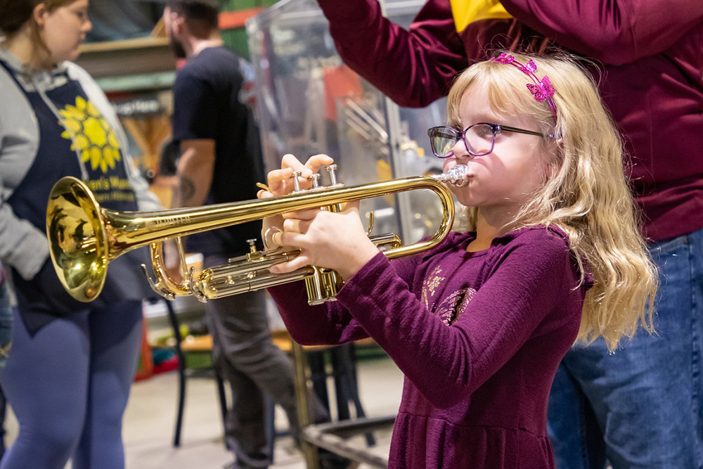 child instrument petting zoo musical event at the Children's Museum