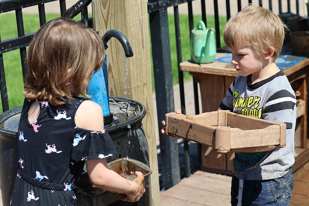 Children playing together in the Mud Kitchen at the Children's Museum in Mankato