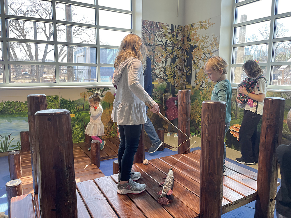 fishing at the Summer Cabin exhibit for kids at the Children's Museum in Mankato
