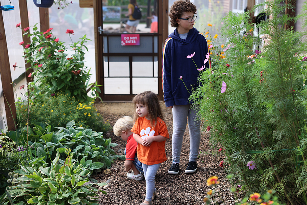 Children in the pollinator flower garden at the Childrens Museum of Southern Minnesota